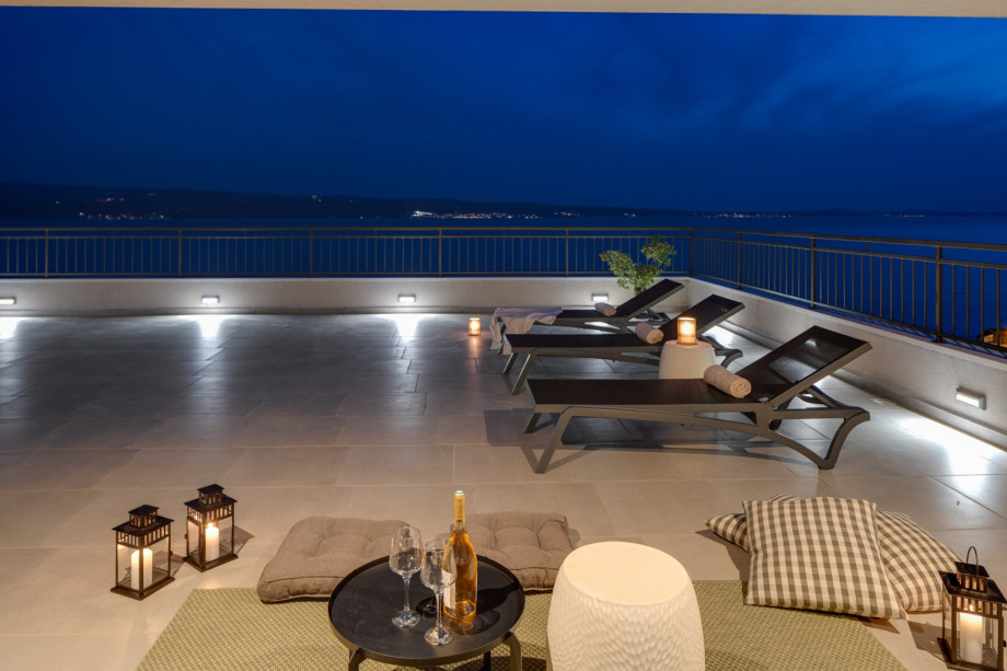 Rooftop terrace with lounge corner and few deck chairs for sunbathing