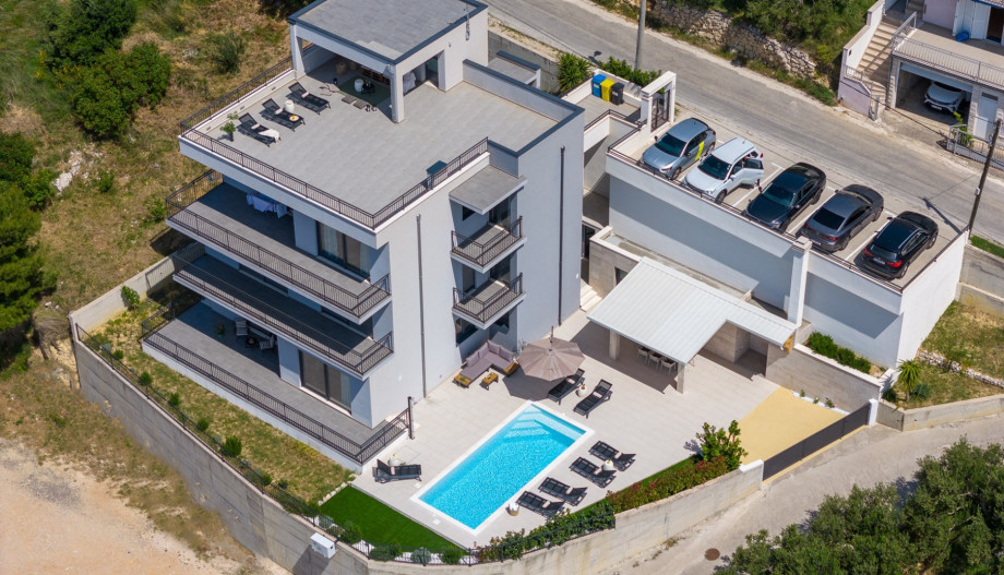 Property is organized across 3 floors: the parking level (second floor), the first floor, and the pool level (ground floor)