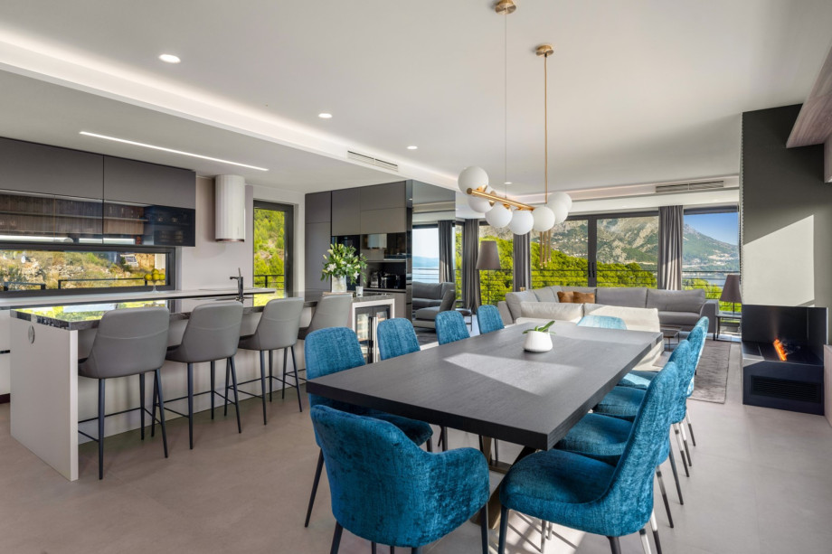 A dining table for 8 people, and a kitchen island with bar stools, the kitchen is equipped with all the amenities you need