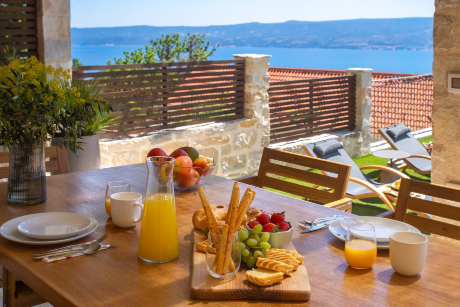 Enjoy outdoor meals in the covered dining area for 6, located just steps away from the private pool.