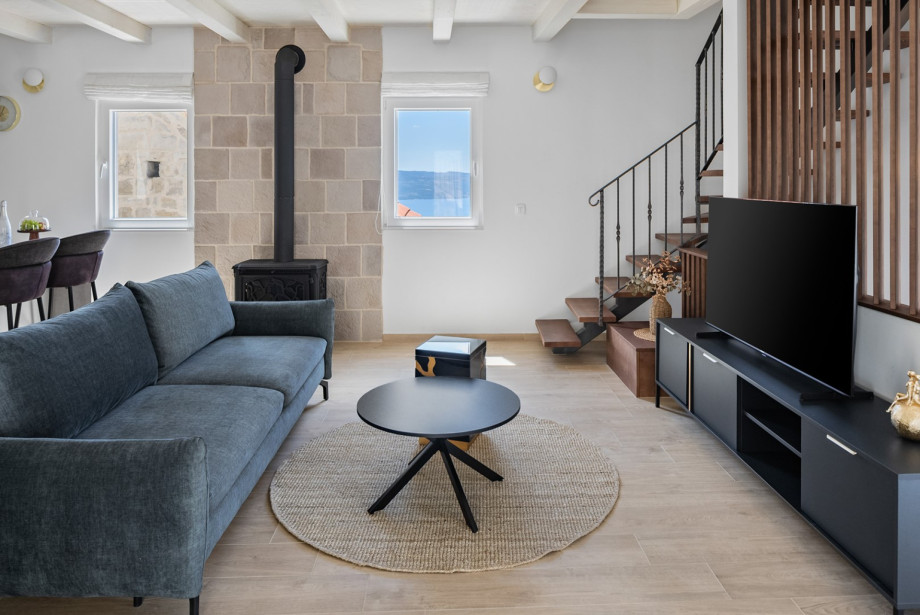 The living area features a smart TV and a PlayStation 5 for your entertainment.