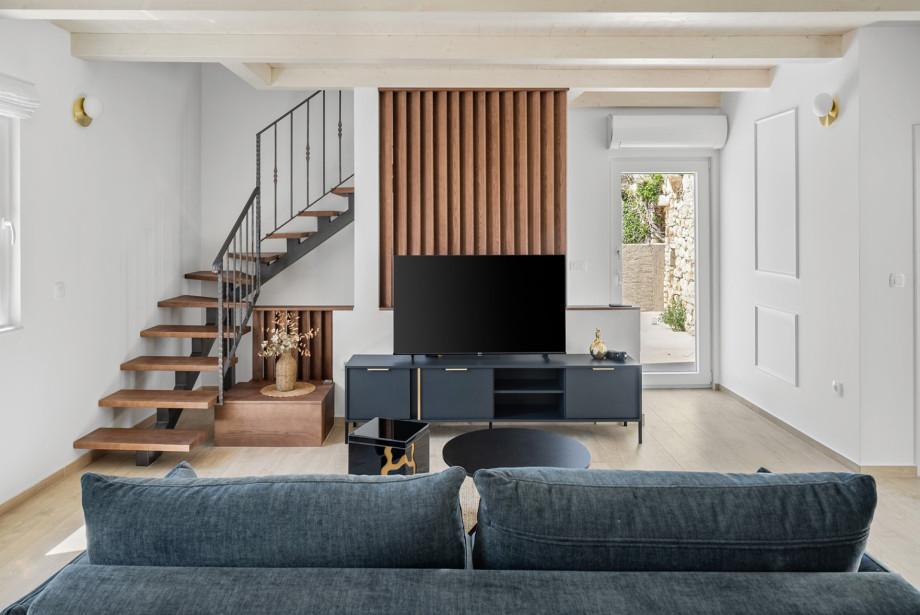Enjoy the stylish ground floor lounge equipped with a smart TV and modern furnishings.