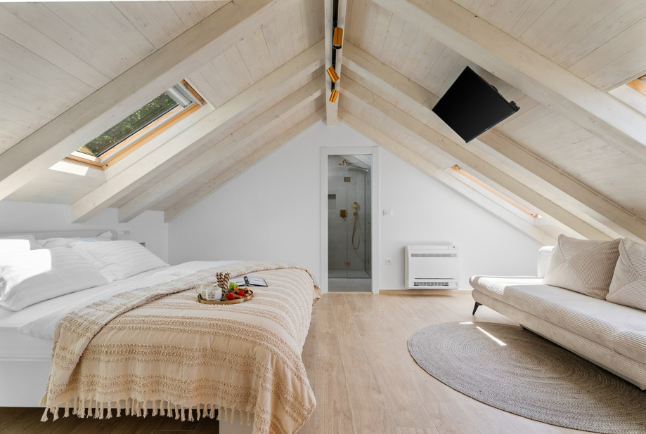 Relax in the 18 sqm attic suite featuring a luxurious king-size bed and private en-suite.
