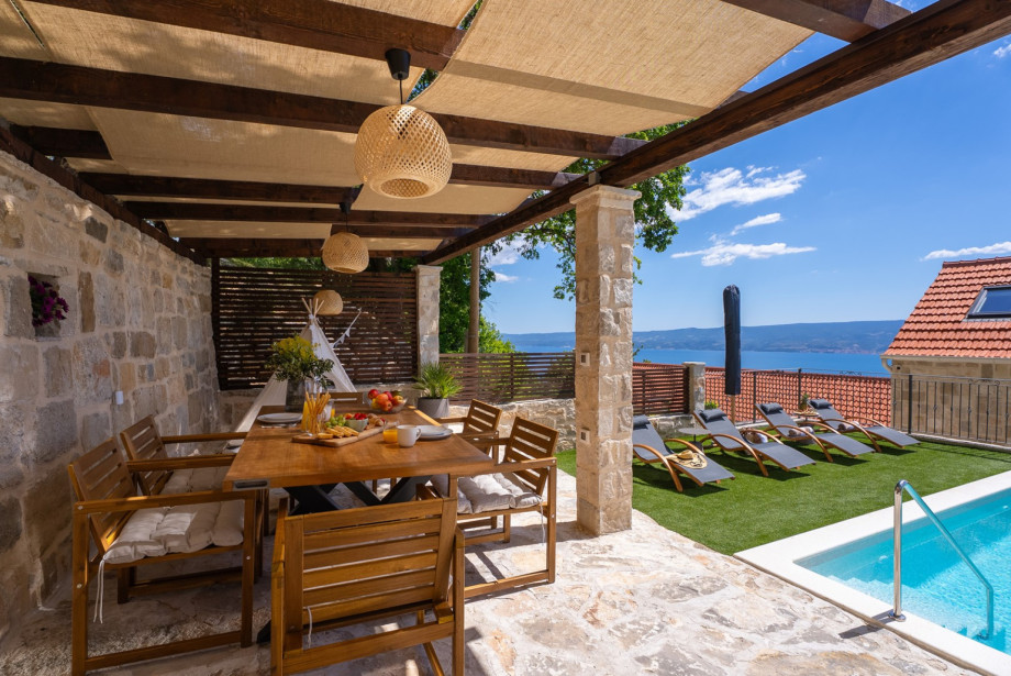 Dine alfresco in the covered outdoor area for 6, located right next to the private pool.