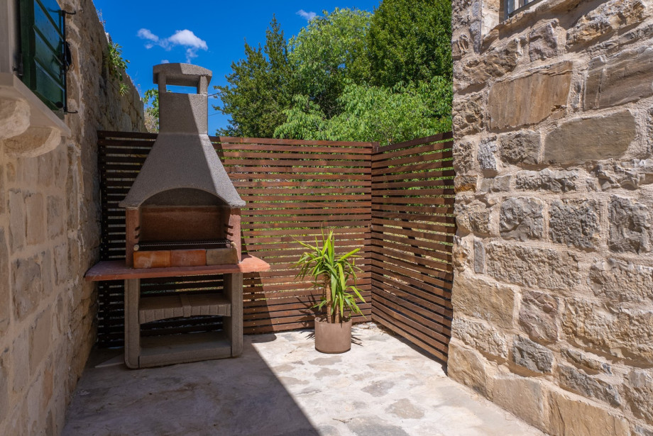 A barbecue area with wood and charcoal is located just steps from the kitchen for perfect outdoor meals.