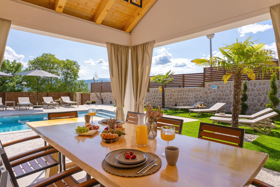 The summer kitchen is located directly next to the pool.