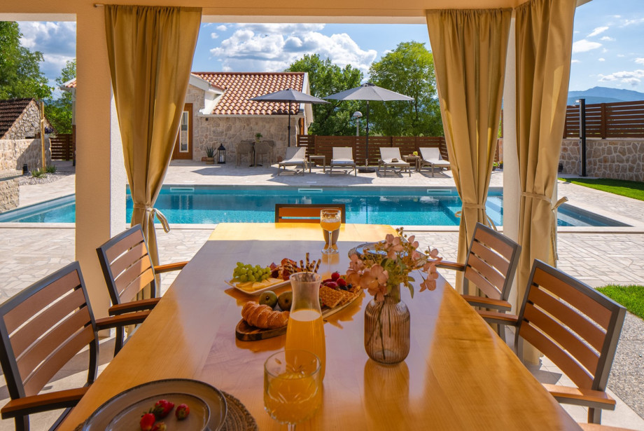 The summer kitchen is located directly next to the pool.