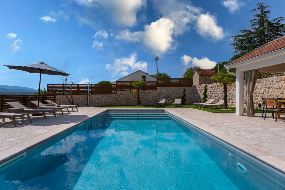 The sun deck features 8 comfortable deck chairs next to the heated pool.