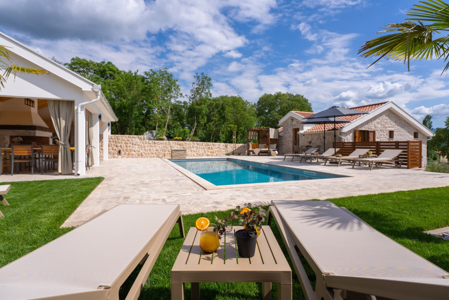 The pool area is designed for relaxation, offering high-quality amenities in a serene rural setting.