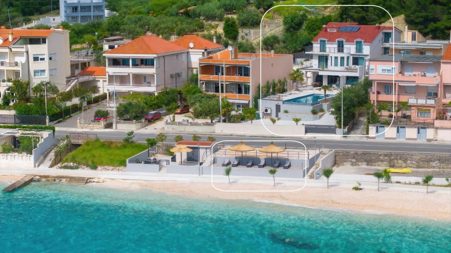 Private beach area with sun loungers reserved exclusively for villa guests.