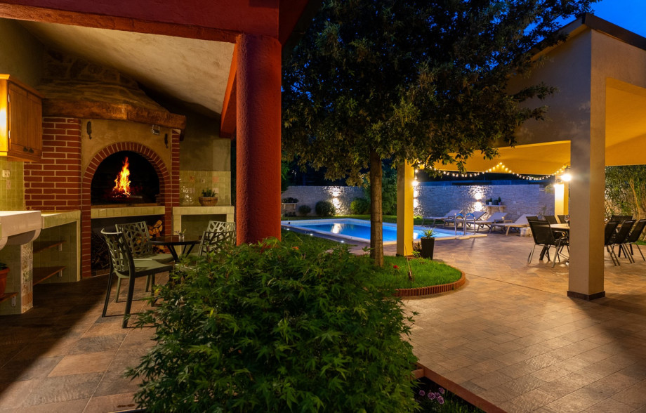 Covered dining area and summer kitchen with a barbecue.