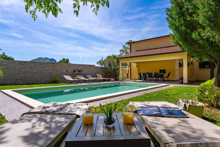 Six comfortable deck chairs on a spacious sun deck by the heated pool.