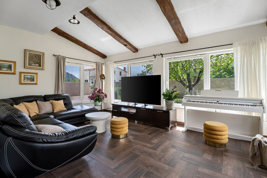 Spacious 36 sqm living area with air-con, TV, and a pianino.