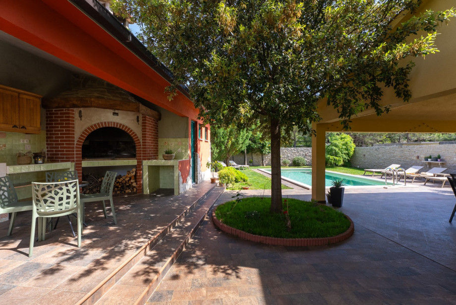 Private pool and summer kitchen nestled in a quiet, green environment.