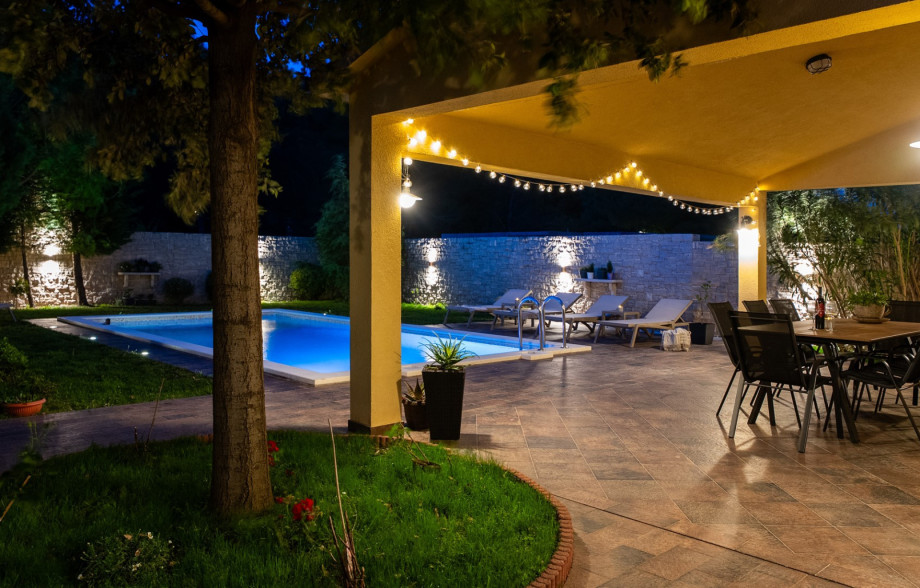 Peaceful garden setting with a covered dining terrace and BBQ.