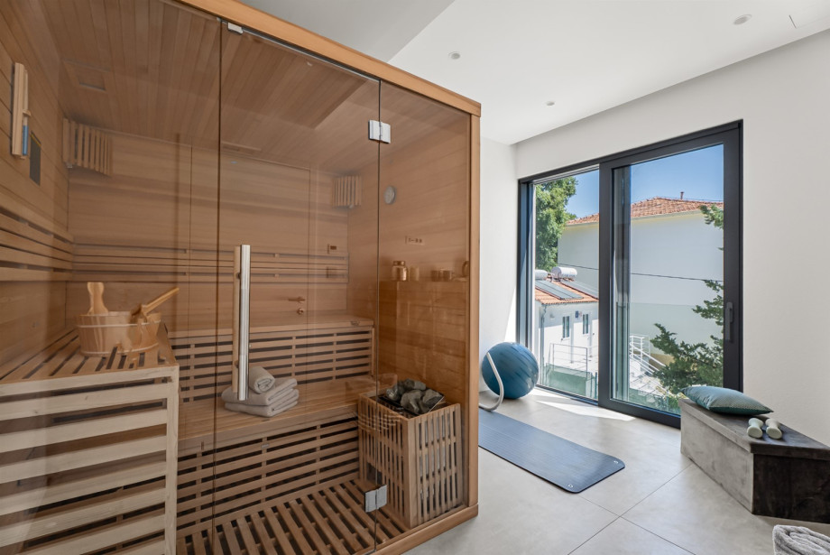 The first floor features a Finnish Sauna room with fitness equipment