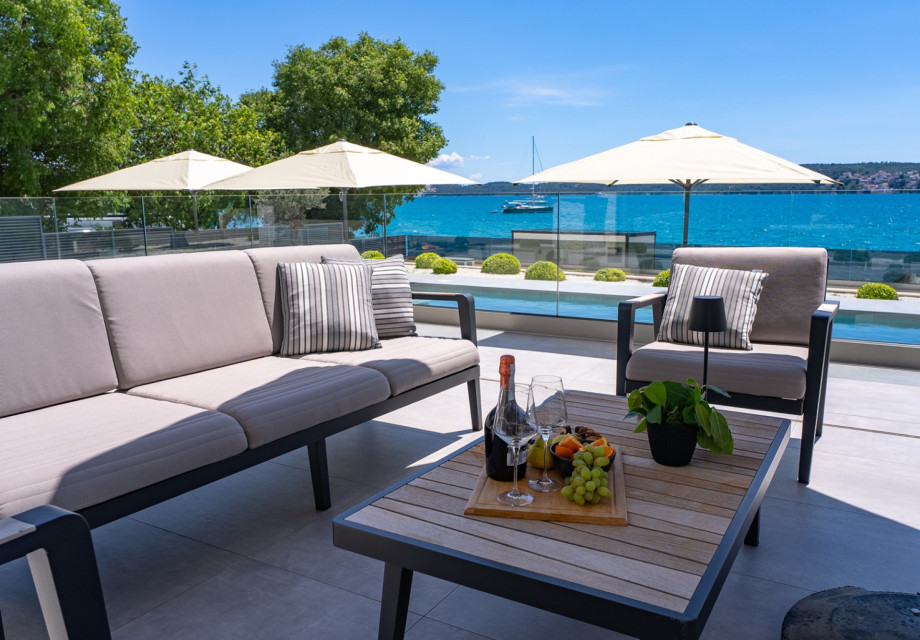 Stylish seaside terrace with comfortable lounge seating and breathtaking ocean views.