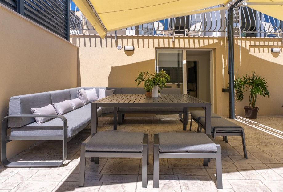 Outdoor area is designed for relaxation and socializing, featuring ten deck chairs around the pool, a lounge area
