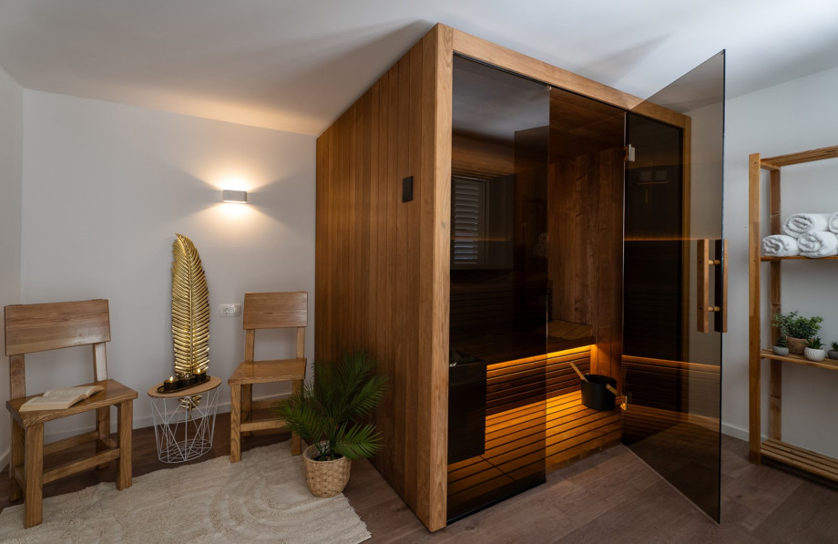 Spa zone includes a Finnish sauna, Orbitrack, yoga mat, and weights