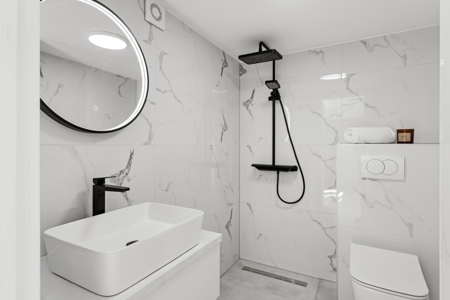 Family bathroom that has a shower, next to the media room