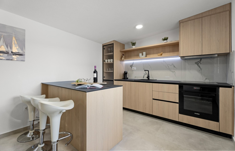 Fully equipped summer kitchen beside spacious indoor dining area