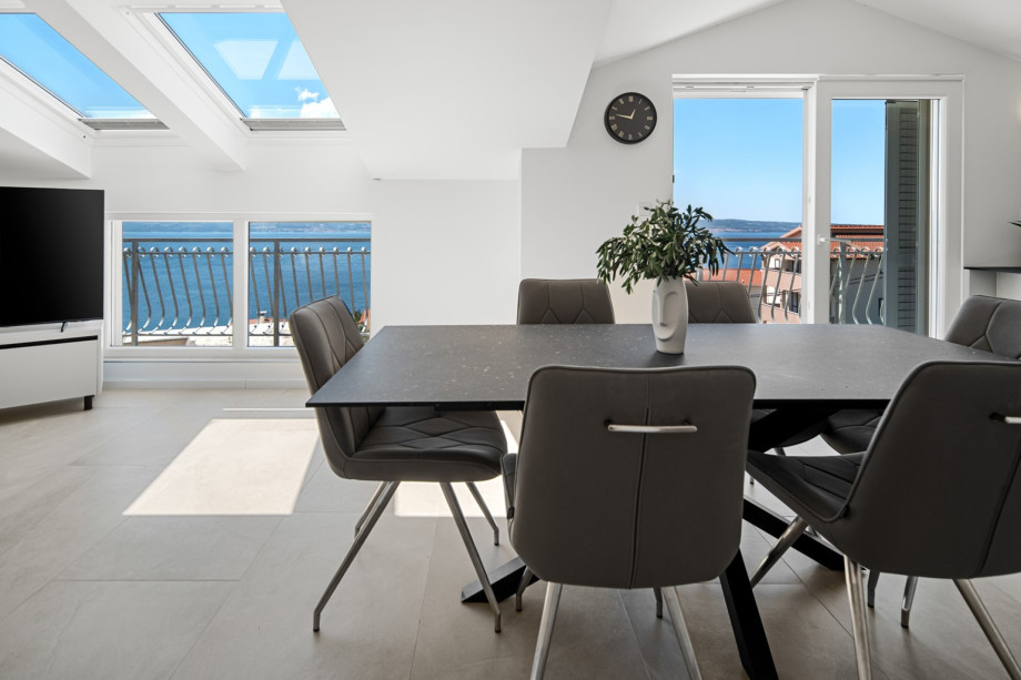 Experience a spacious open-plan layout featuring a dining table for six guests