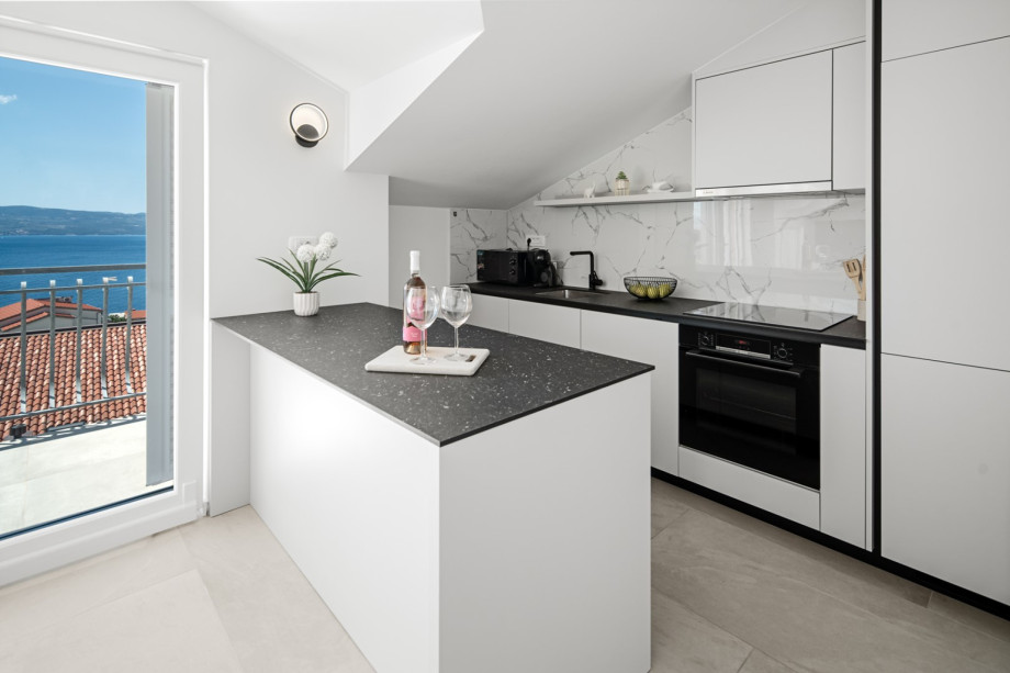 Second floor offers fully equipped and air-conditioned kitchen with a kitchen island