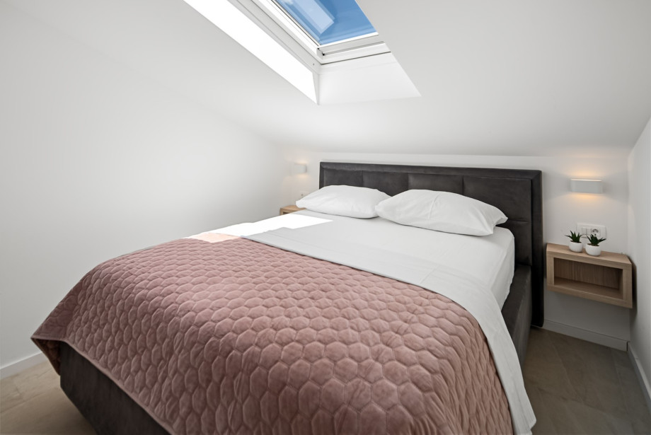 Bedroom 2 (10 sqm) with a queen-size bed (160 cm x 200 cm), A/C, and an en-suite bathroom