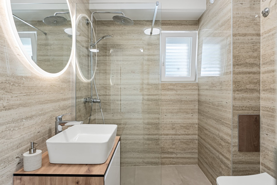 En-suite bathroom that includes a shower, towels are provided