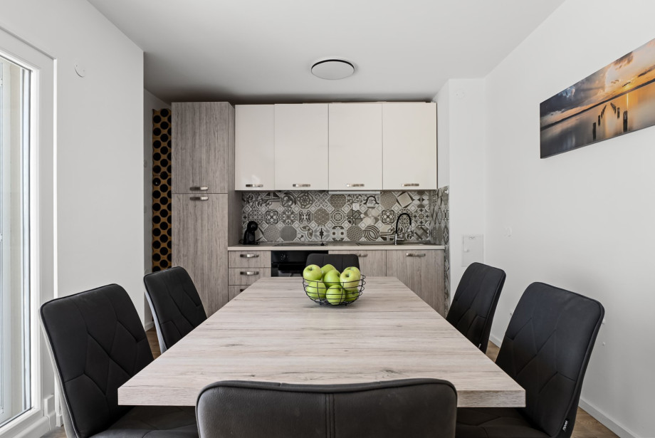 Fully equipped and air-conditioned kitchen, a dining table