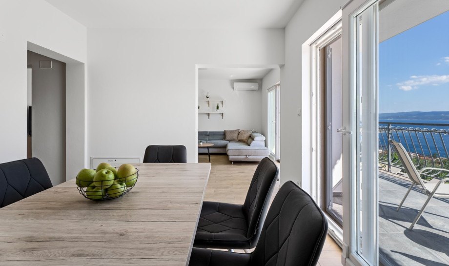 Living area with balcony and sea views