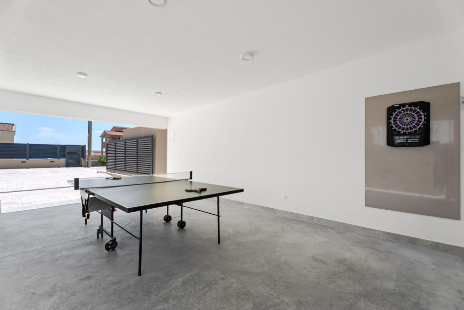 Covered entertainment area with table tennis and darts