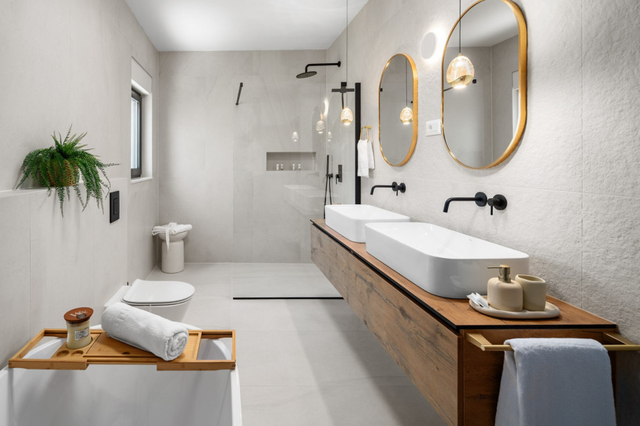 Spacious family bathroom with bathtub, shower, and dual sinks