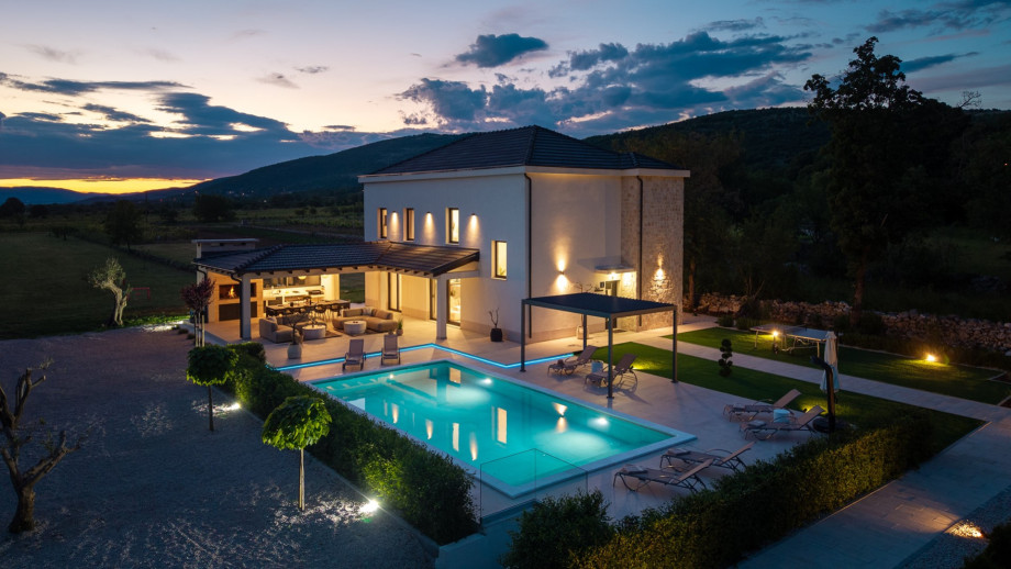 The tranquil surroundings effortlessly blend indoor and outdoor living, allowing for seamless gatherings and unforgettable moments