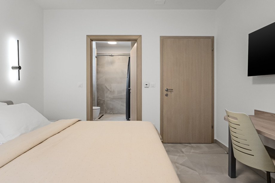 Bedroom No. 4 also offers a TV, air conditioning, and an en-suite bathroom with a shower