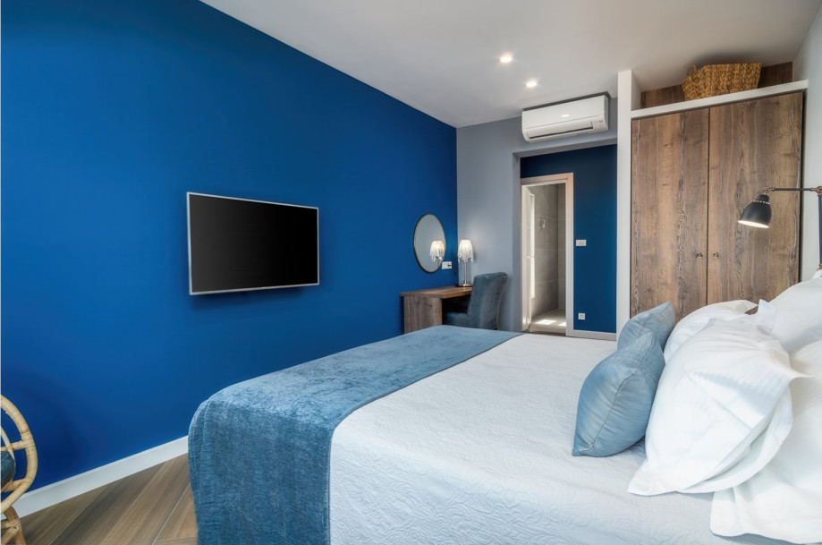 Bedroom No1 with a king-size bed 180x200cm, TV, A/C, en-suite bathroom with a shower, and a balcony