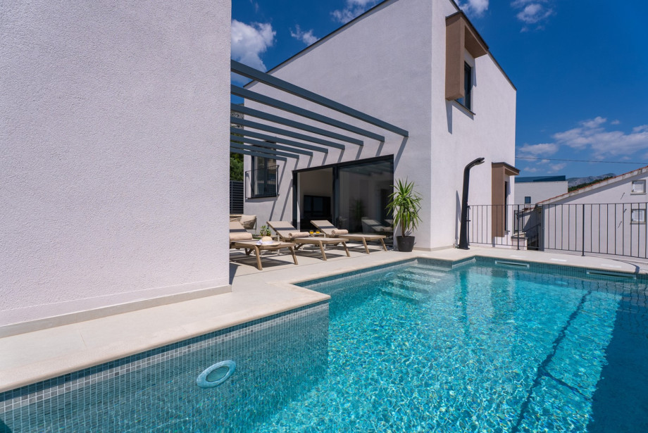 Relax by the private heated pool, located just 150 meters from the sea.