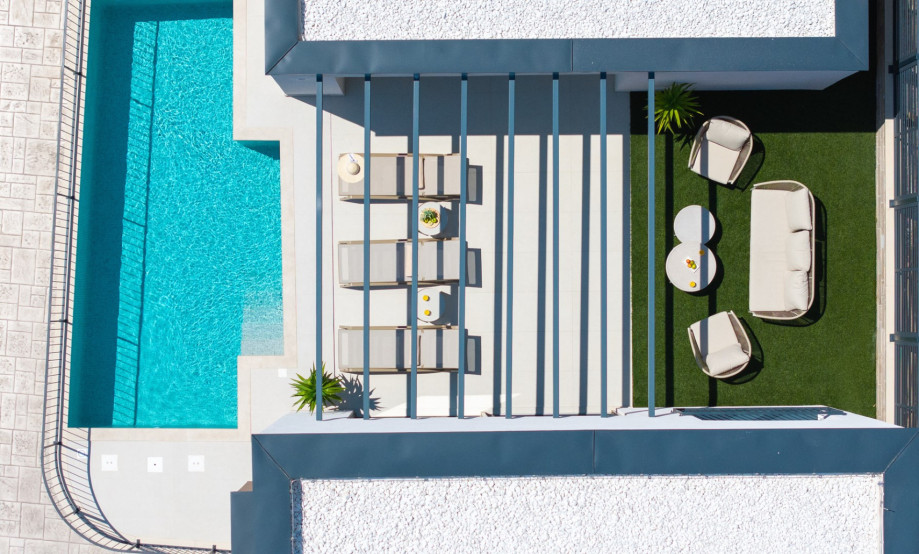Surrounding the private pool is a sun deck equipped with comfortable deck chairs.