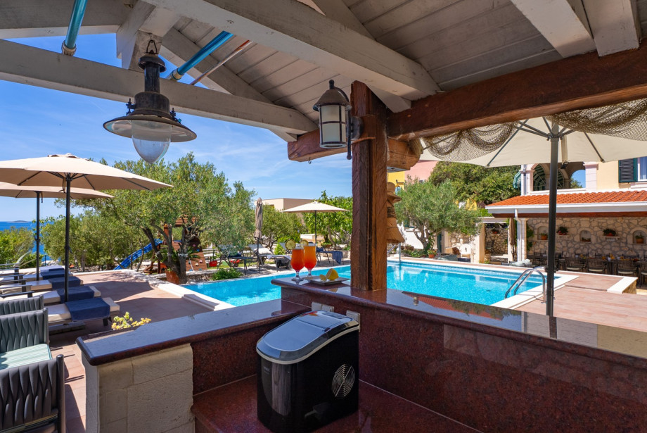 Sun deck area with chairs next to the private 6m x 8m outdoor pool.