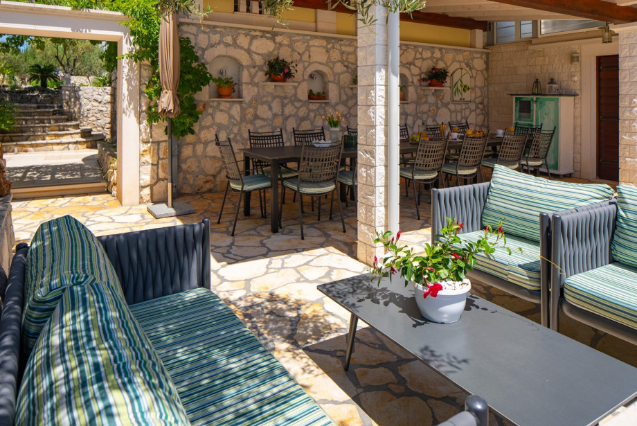 The outdoor lounge corner offers comfortable seating right by the pool.