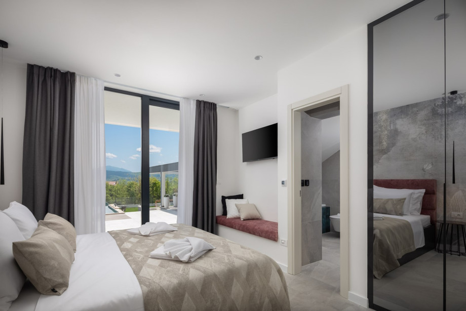 Bedroom No3 (17.5sqm) with king-size bed 180cm x 200cm, A/C, TV, en-suite bathroom (4sqm) with shower and a bathtub, and direct approach to the pool area