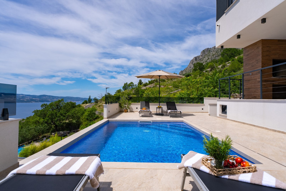 The sun deck area is equipped with eight deck chairs and two sun umbrellas