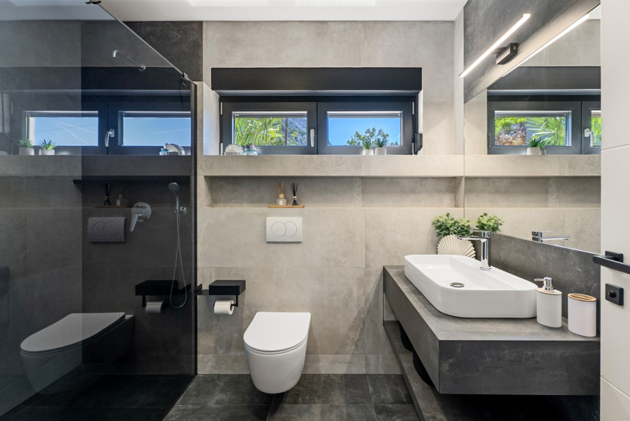A family bathroom with a shower is conveniently situated in front of the bedroom.