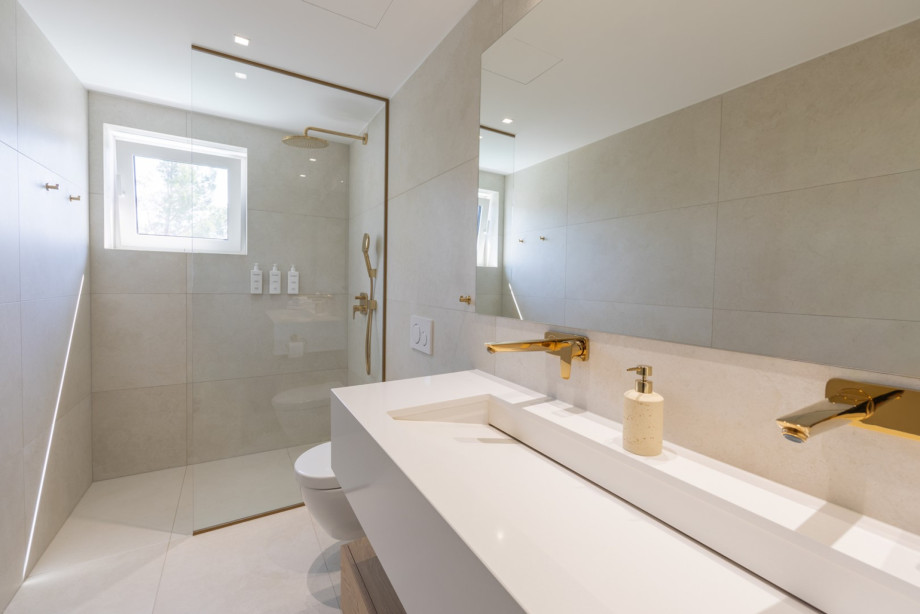 Ein eigenes Badezimmer mit Dusche, Doppelwaschbecken und WC