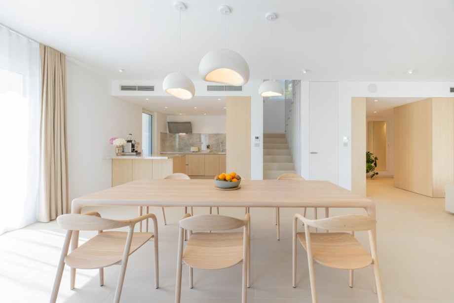 The light wooden table and refined chairs create an elegant space for shared meals