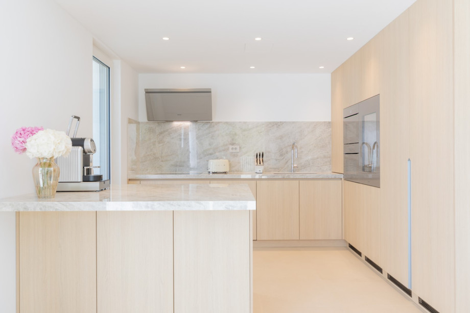 The fully equipped kitchen is a culinary sanctuary, featuring opulent quartz finishes and state-of-the-art Miele and Smeg appliances, elevating your cooking experience