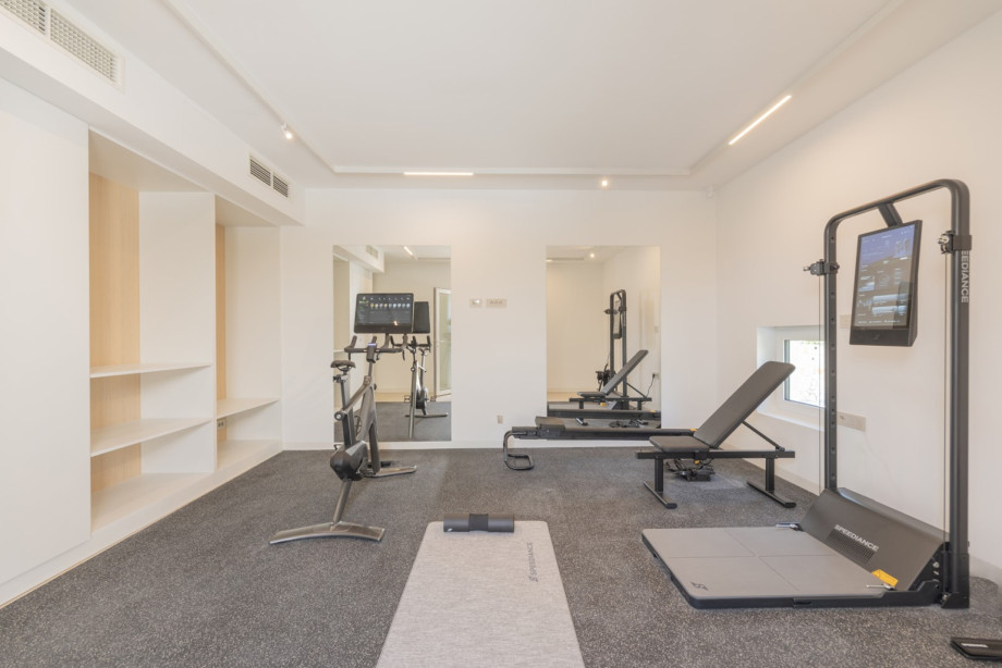 Private smart gym equipped with Speediance training equipment, cardio machines, and a functional workout area