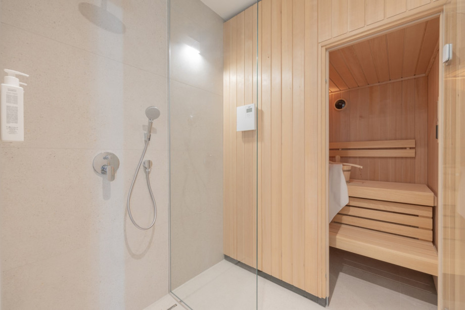 Wellness bathroom with a private sauna, walk-in shower, gold-toned fixtures, and award-winning Natura Bissé cosmetics