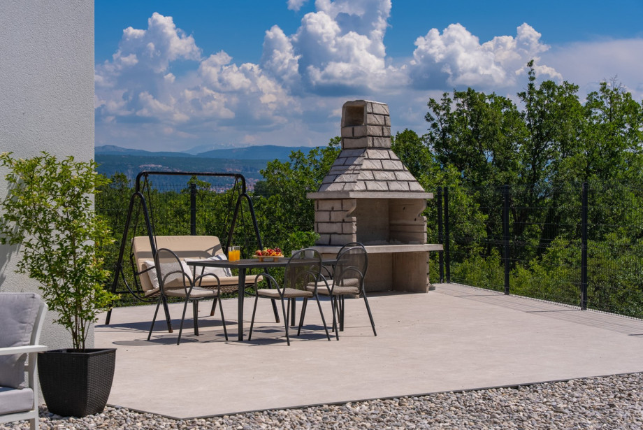 And an outdoor dining table complete with barbecue facilities for wood or charcoal grilling.