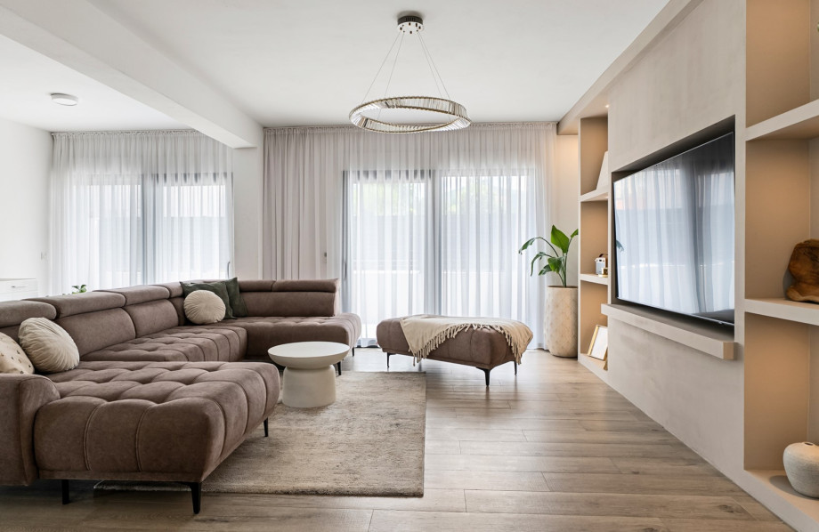 Cozy lounge featuring a comfortable sofa and flat-screen TV.